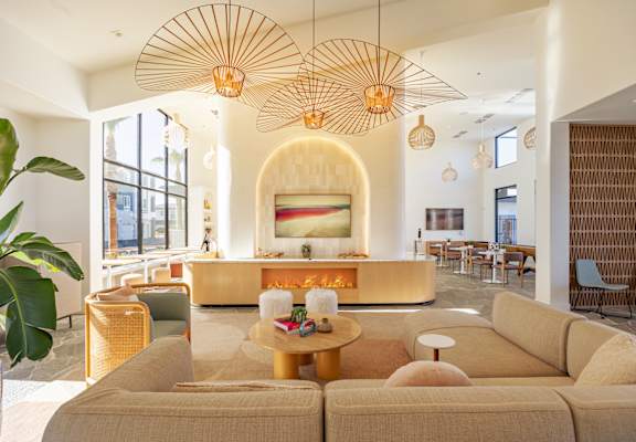 A living room with a large couch and a fireplace.