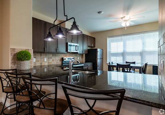 an open kitchen and dining area with a table and chairs