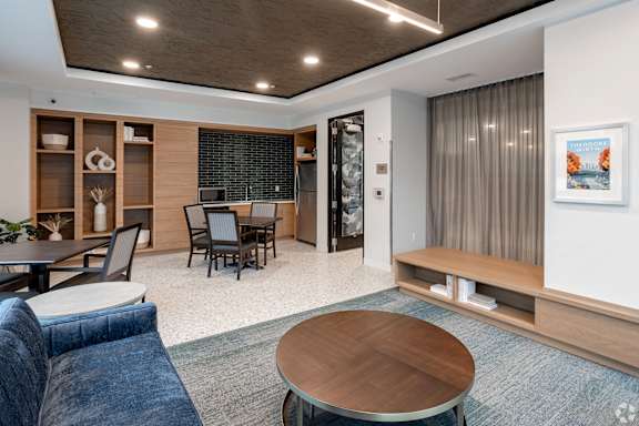 a living room and dining room with a table and chairs