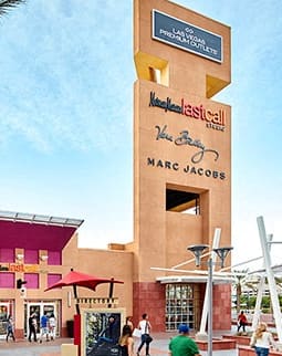 an exterior view of a mall with palm trees