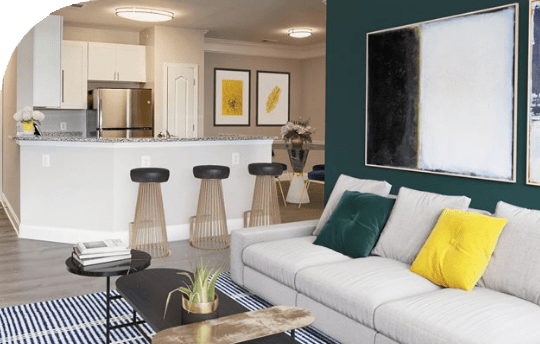 a living room with a white couch and a kitchen