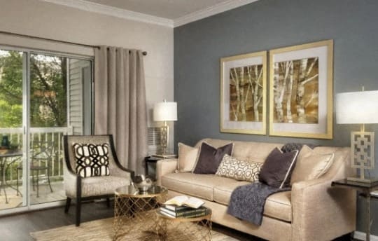 a living room with a couch and a chair and a window at The Morgan Apartment Homes, Maryland