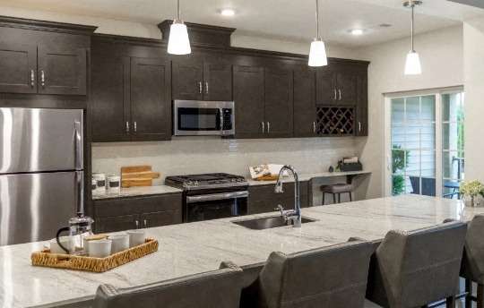 a kitchen with a large island and a stainless steel refrigerator at Siena Luxury Residences Apartments, Cinnaminson, 08077