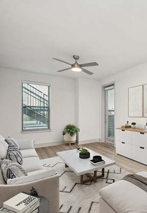 Model Living Room with Wood-Style Flooring and Patio Accessibility at Alta 3Eighty Apartments located in Aubrey, TX-SMLAM.