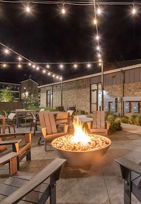 Outdoor Fire Pit Area with Lounge Furniture at Alta 3Eighty Apartments located in Aubrey, TX-SMLAM.