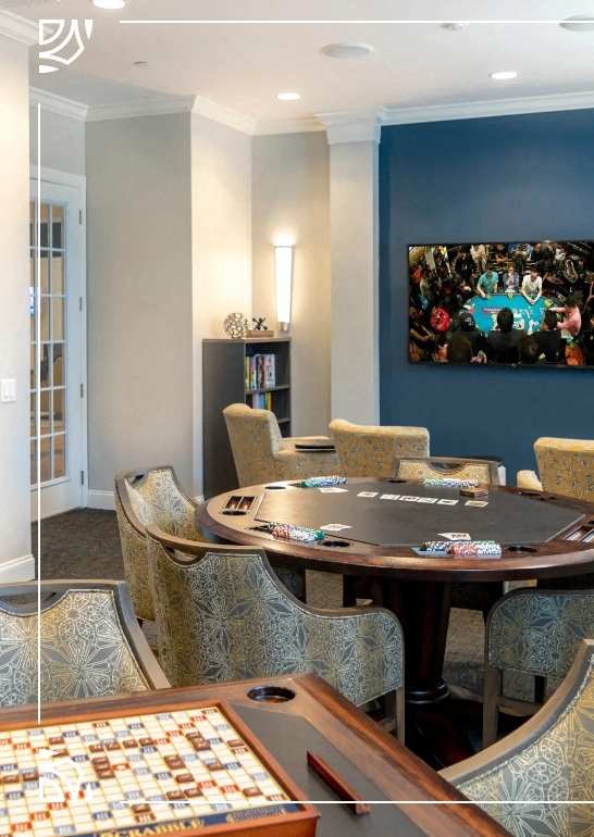 a poker table in a room with chairs and a tv at Siena Luxury Residences Apartments, Cinnaminson, 08077