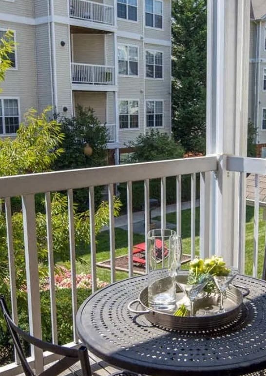 a patio with a table and chairs on a balcony at The Morgan Apartment Homes, Maryland