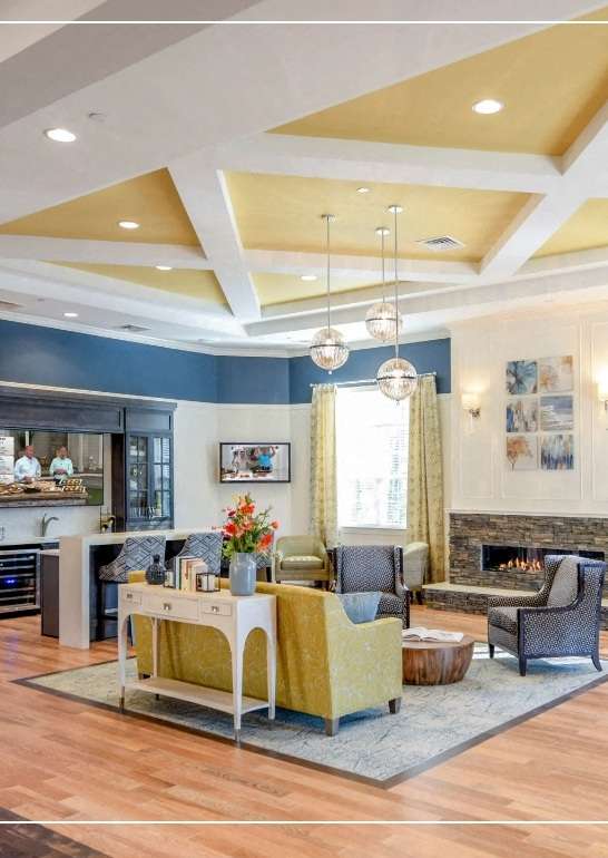 a living room with a table and chairs and a fireplace at Siena Luxury Residences Apartments, Cinnaminson, 08077