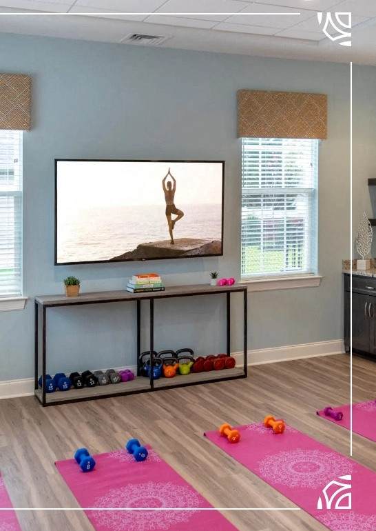 a yoga room with yoga mats on the floor and a tv on the wall at Siena Luxury Residences Apartments, Cinnaminson, 08077
