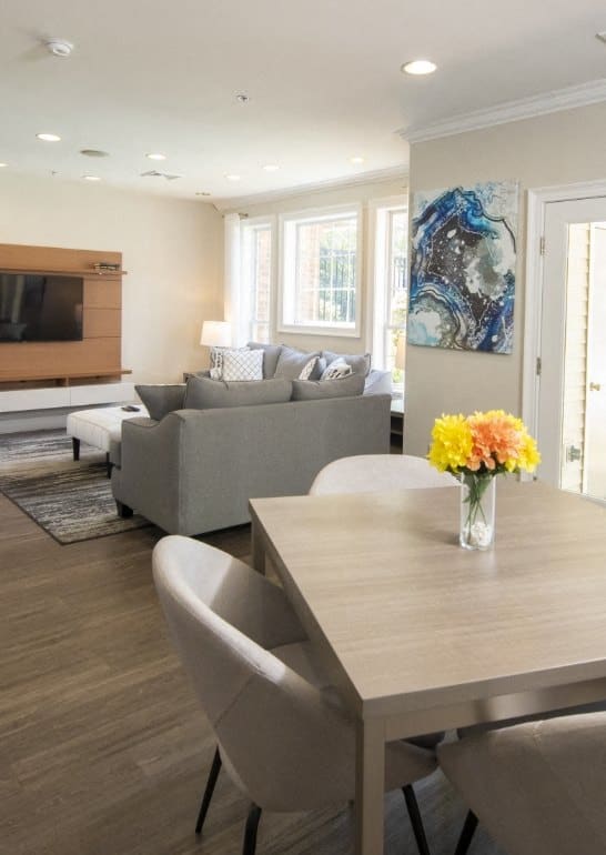 a living room and dining room with a table and chairs at The Morgan Apartment Homes, Maryland