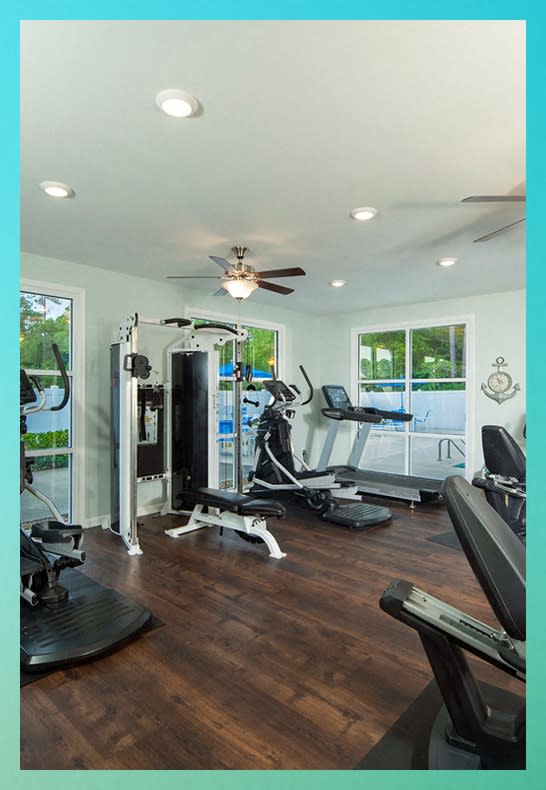 a home gym with exercise machines and a ceiling fan at River Oaks, Little River