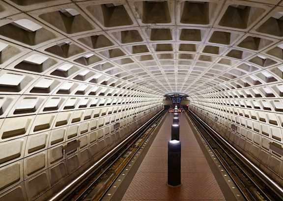 A subway station with a train on the tracks.