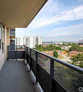 a view of the city from the balcony of an apartment