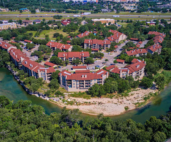 an aerial view of an apartment complex next to a river at Waters Edge Apartment Homes, Georgetown, 78626