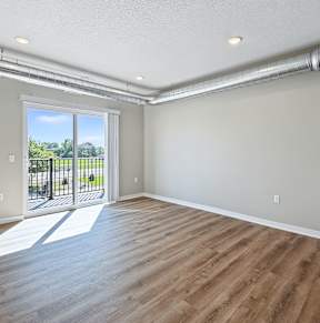 A room with wooden floors and white walls at Siena Crossing Apartments, Ankeny, IA, 50223