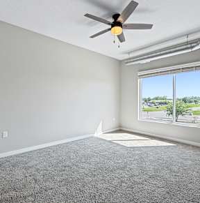 A room with wooden floors and white walls at Siena Crossing Apartments, Ankeny, IA, 50223