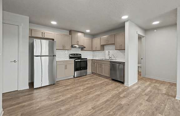 Kitchen with wooden floor at The Collective on 13th Apartments, Charles City, IA, 50616