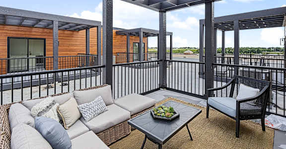 Patio with couch at The Flats at West Glen Apartments, West Des Moines