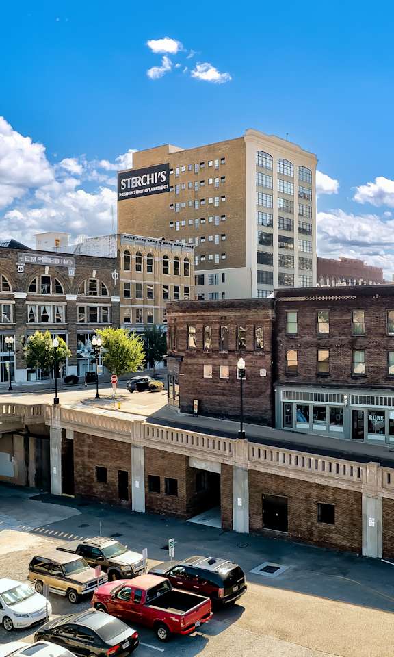 A parking lot with cars and a building with a sign that says "St. Croix's".