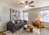 Thumbnail 4 of 19 - A living room with a grey couch, a coffee table, and a painting on the wall. at Highland Park, Texas, 76132