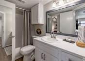 Thumbnail 3 of 19 - A bathroom with a white toilet, sink, and mirror. at Highland Park, Texas, 76132