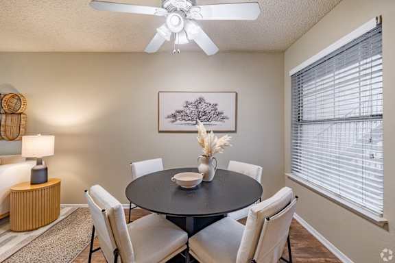 A dining room with a round table and chairs. at Highland Park, Texas, 76132