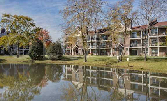 A large building is reflected in the water.