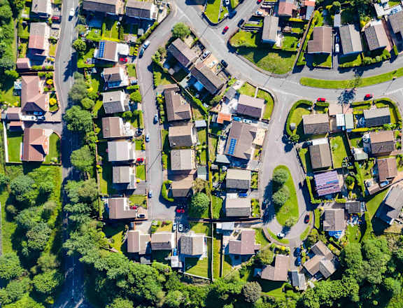 an aerial view of a neighborhood with houses and trees