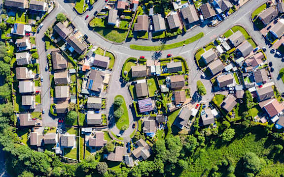 an aerial view of a neighborhood with houses and trees