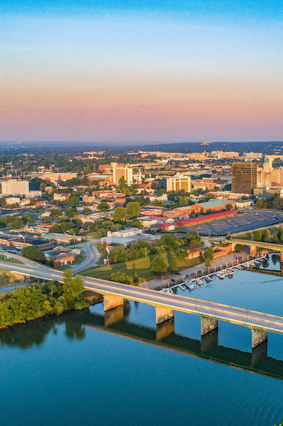 A cityscape with a river and a bridge.