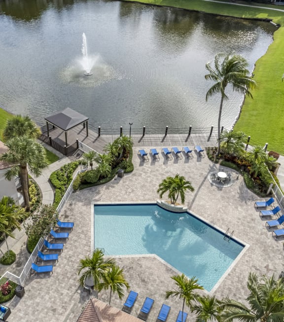 a backyard with a pool and a pond with a fountain