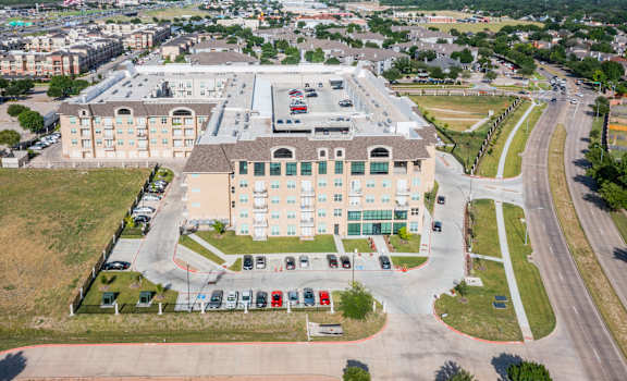 an aerial view of building with car parking at Residences at 3000 Bardin Road, Grand Prairie, Texas