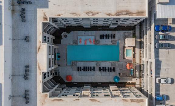 an aerial view of a building with a blue pool at Residences at 3000 Bardin Road, Texas, 75052