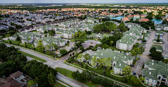 an aerial view of a neighborhood with green roofs and trees