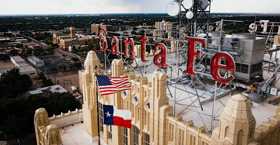 A large Santa Fe sign is displayed on a building.