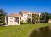 Thumbnail 37 of 46 - exterior of 3 story apartment building near lake at Cypress Legends, Fort Myers
