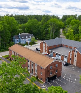 arial view of a red brick building with a brown roof