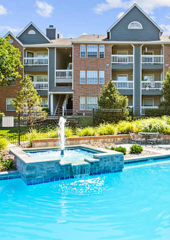 arial view of a swimming pool in a backyard with lounge chairs and treesat Stonebriar Apartments, Overland Park, 66213