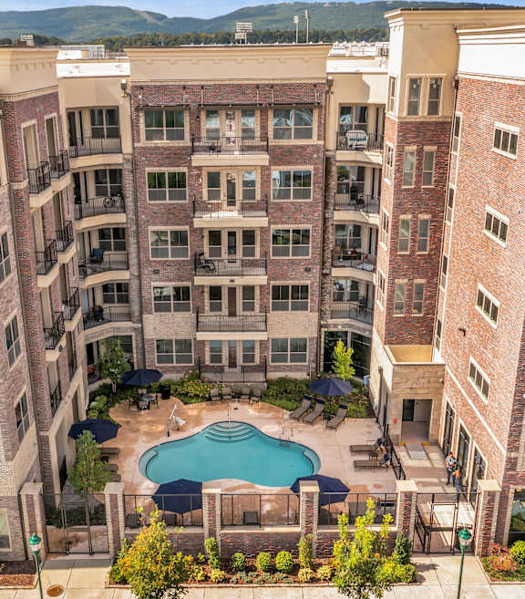 an aerial view of a large apartment building with a swimming pool