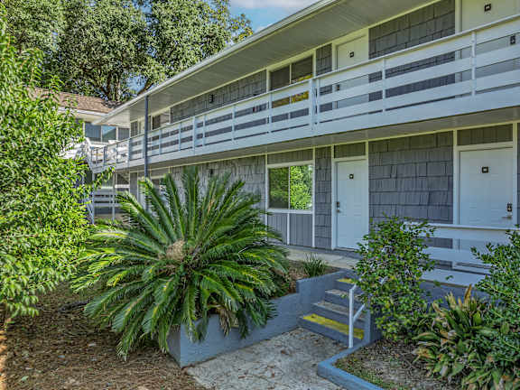 A white building with a balcony and a door. at The Sanctuary, Tallahassee, 32304