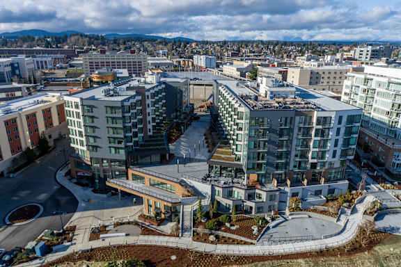 A modern building complex with a circular courtyard in the center.