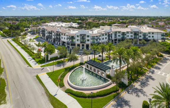an aerial view of the resort properties with a fountain in the middle of a grassy area