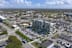 an aerial view of a city with a large building and parking lot