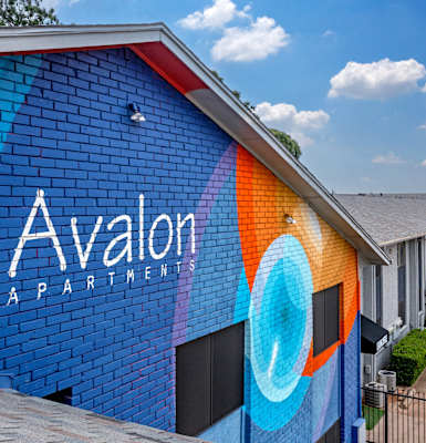 a blue brick building with the words avalon partnership painted on it