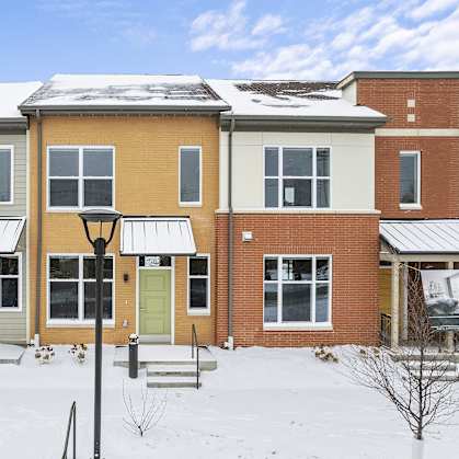 a row of houses in the snow