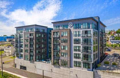 a rendering of a two story apartment building with a blue sky in the background