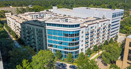 an aerial view of a large building surrounded by trees