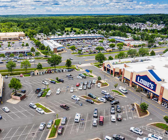 A Lowe's store is seen from above with a parking lot full of cars.