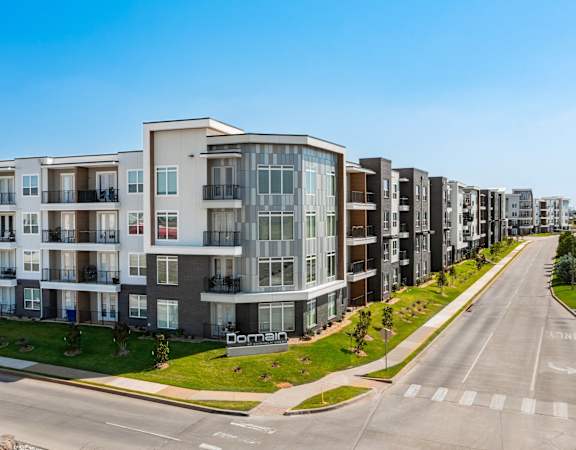 a large apartment building on the side of a street
