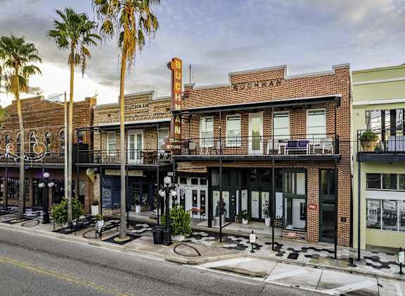 a street view of a row of buildings on a street corner